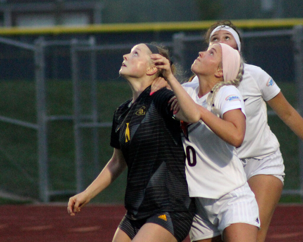 From left to right, Denaya Evans of Ottawa University, Kaymyn Brane of Stephens College, and Alivia Messina of Stephens College look up in the air at the ball during